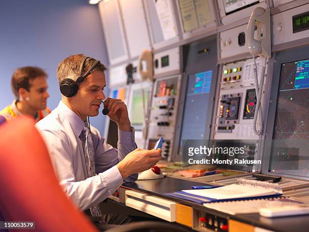 air traffic controllers in radar room - airport ground crew stock pictures, royalty-free photos & images