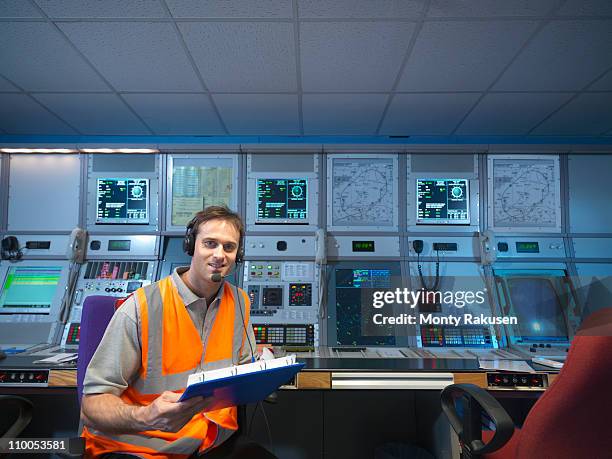 air traffic controller in radar room - departure board front on fotografías e imágenes de stock