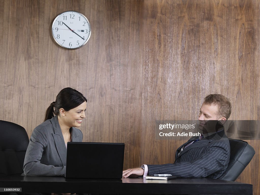 Business man and woman at desk