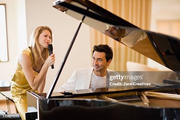 couple singing and playing piano - pianist front stock pictures, royalty-free photos & images