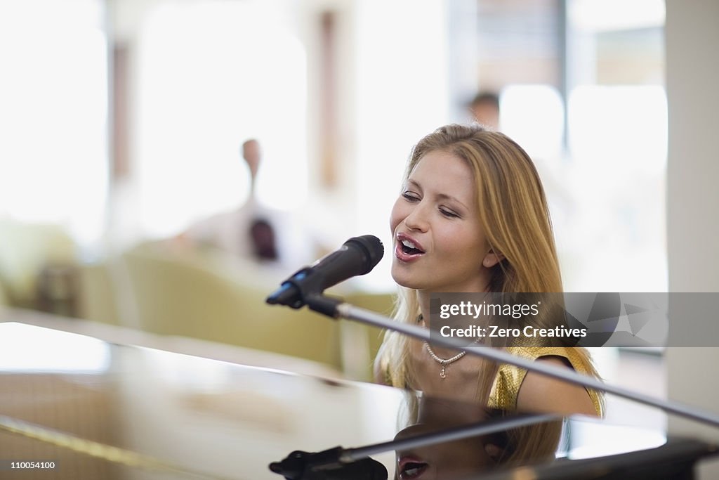 Girl singing and playing piano