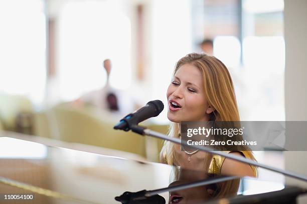 girl singing and playing piano - pianist stock pictures, royalty-free photos & images