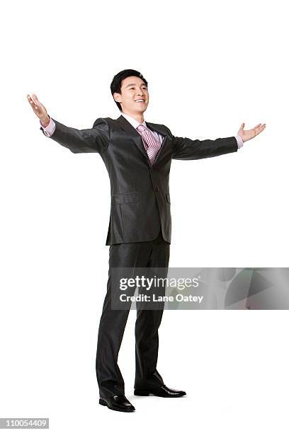 full length of businessman with arms outstretched - man standing full length side stock-fotos und bilder