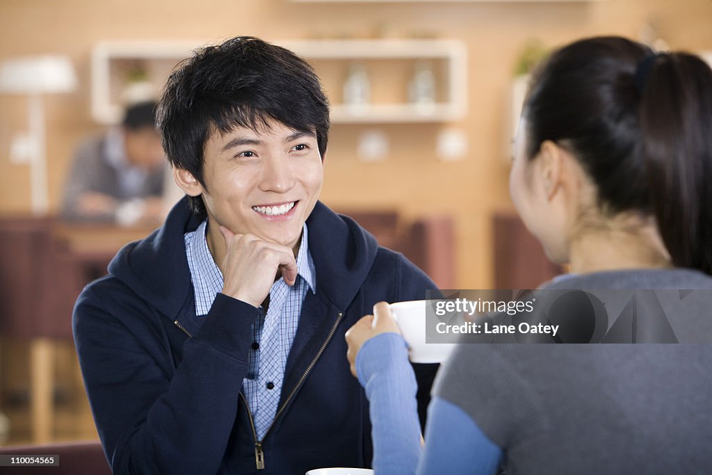 Man and woman talking over coffee