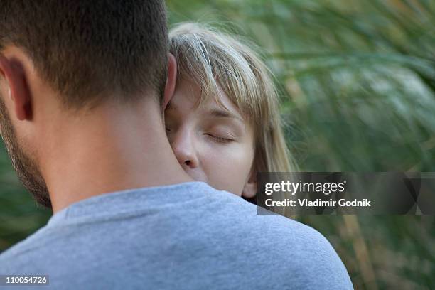 couple embracing - head on shoulder stock pictures, royalty-free photos & images