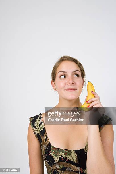 woman on banana phone - banana phone stock pictures, royalty-free photos & images