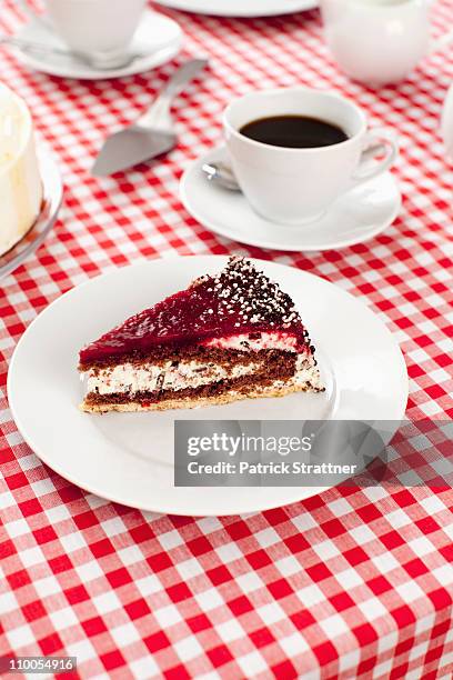 a slice of cake and cup of coffee - black forest gateau stock-fotos und bilder