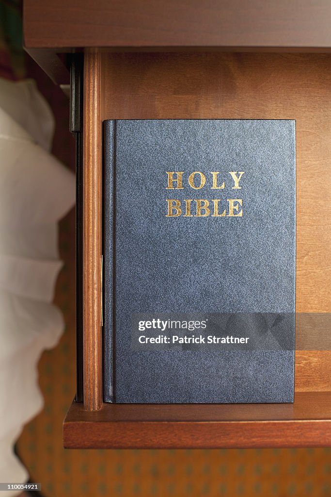 A bible in a night table drawer in a hotel room