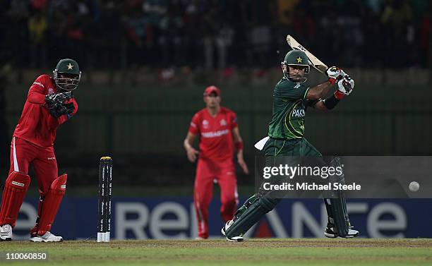 Mohammad Hafeez of Pakistan hits to the offside as wicketkeeper Tatenda Taibu looks on during the Pakistan v Zimbabwe 2011 ICC World Cup Group A...