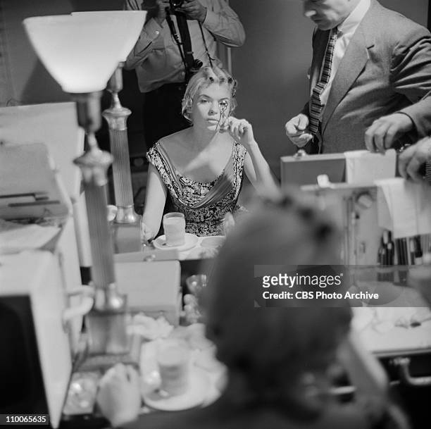 Jayne Mansfield getting ready for her appearance on PERSON TO PERSON. Image dated May 4, 1956.