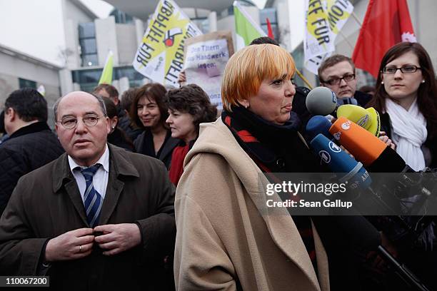 German Greens Party co-leader Claudia Roth speaks to the media as Die Linke Bundestag faction leader Gregor Gysi waits his turn during an...