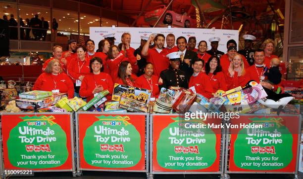 Joey Fatone, U.S Marines, and Contestants pose at the Bank Of America Keep The Change Round Up Relay a shopping spree which Joey Fatone and 25...