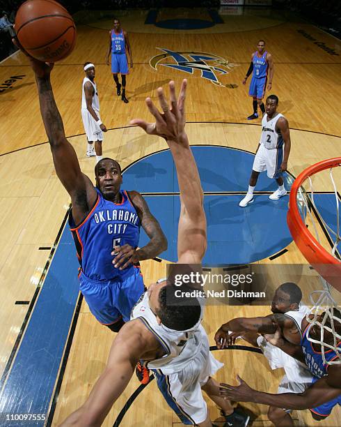 Kendrick Perkins of the Oklahoma City Thunder shoots against JaVale McGee of the Washington Wizards on March 14, 2011 at the Verizon Center in...