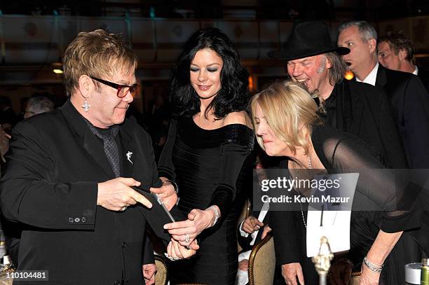 Elton John, Catherine Zeta-Jones, Neil Young and Pegi Young attend a dinner for the 26th annual Rock and Roll Hall of Fame Induction Ceremony at The...