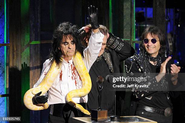 Inductees Alice Cooper and Dennis Dunaway of Alice Cooper Band pose with a snake and accept their award onstage at the 26th annual Rock and Roll Hall...