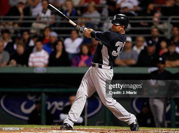 Outfielder Nick Swisher of the New York Yankees fouls off a pitch against the Boston Red Sox during a Grapefruit League Spring Training Game at City...