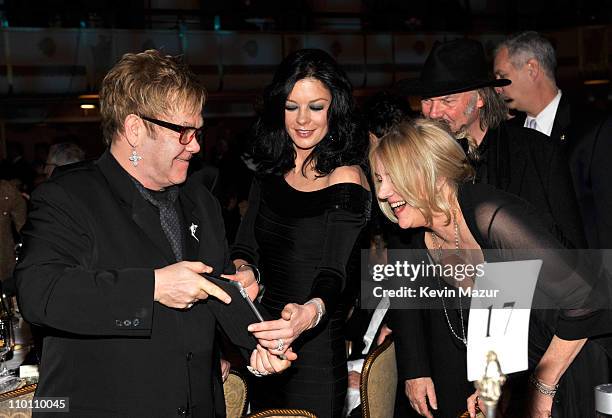 Elton John, Catherine Zeta-Jones, Neil Young and Pegi Young attend a dinner for the 26th annual Rock and Roll Hall of Fame Induction Ceremony at The...