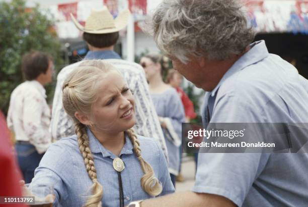 American actress Charlene Tilton with the director on the set of the television soap opera 'Dallas', circa 1980.