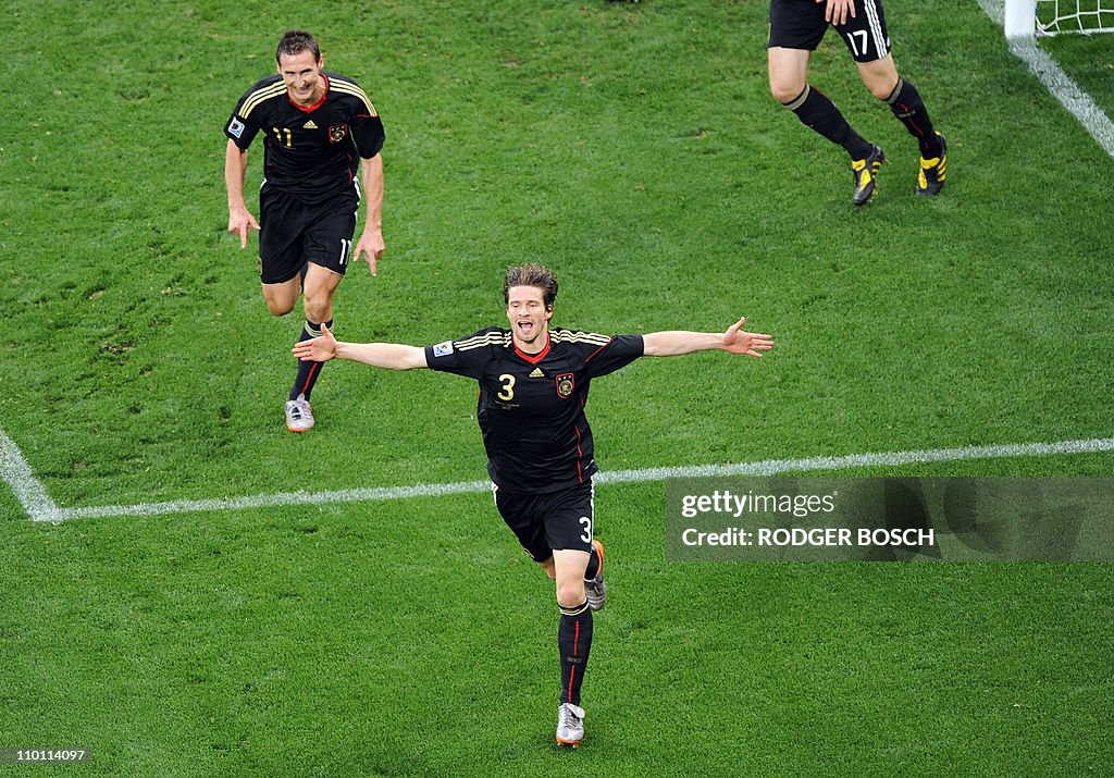 Germany's defender Arne Friedrich (C) is