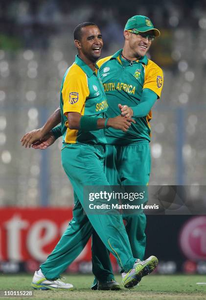 Robin Peterson of South Africa celebrates the wicket of Gary Wilson of Ireland with Francois du Plessis during the 2011 ICC World Cup Group B match...