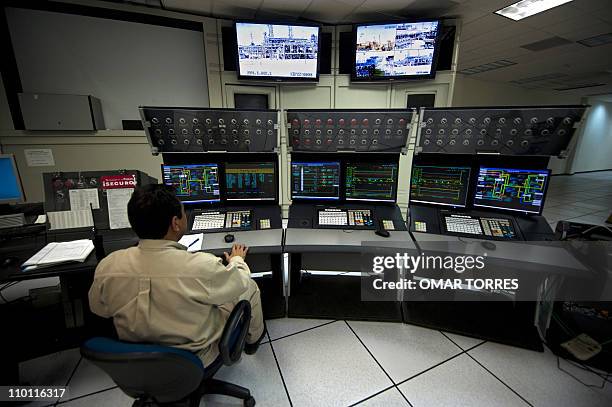 Man works at a control station at Mexican state-owned petroleum company PEMEX refinery in Tula, Hidalgo state, Mexico on March 8, 2011. AFP...