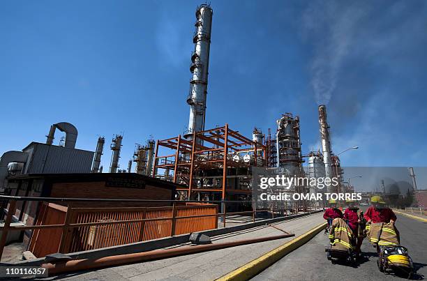 Firemen walk in front of one of the structures to refine oil at Mexican state-owned petroleum company PEMEX refinery in Tula, Hidalgo state, Mexico...