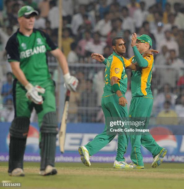 Robin Peterson of South Africa celebrates the wicket of Kevin O'Brien of Ireland with Faf du Plessis during the ICC Cricket World Cup match between...