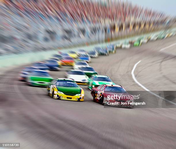 race cars racing around a track. - car racing stock-fotos und bilder