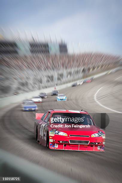 race cars racing around a track. - american muscle car stock-fotos und bilder