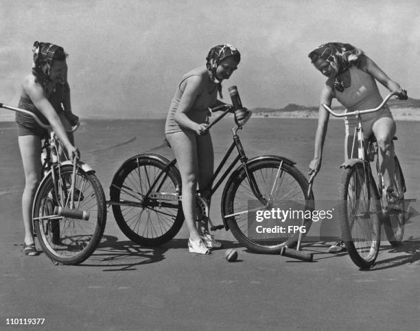 Louise Jobb, Sylvia Young and Eleanor Sturgell playing bicycle polo on a beach at Gearhart, Oregon, circa 1940.