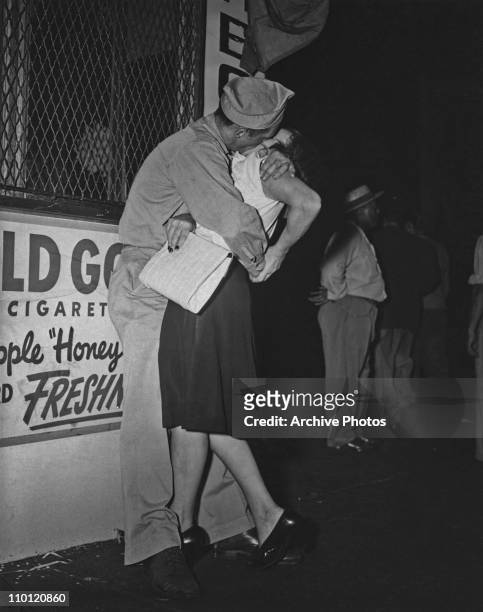 An American serviceman kissing a woman on V-J Day, New York City, 14th August 1945.