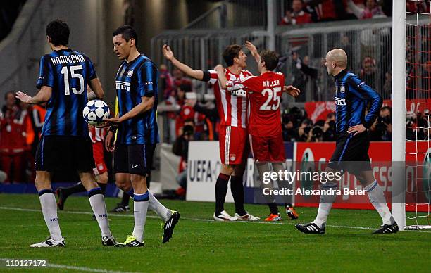 Mario Gomez of Bayern Muenchen celebrates his first goal with teammate Thomas Mueller as Andrea Ranocchia , Lucio and Esteban Cambiasso of Inter...