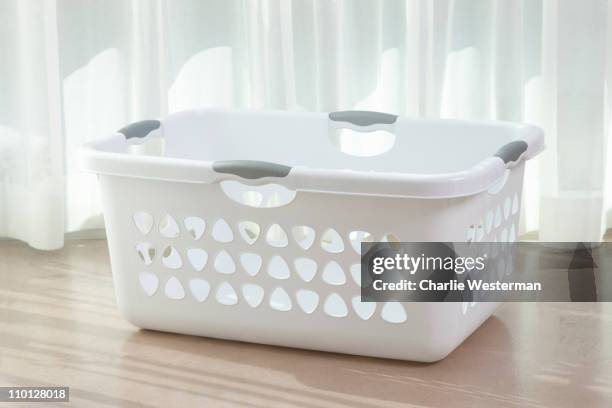 empty white laundry basket on floor. - laundry basket stock pictures, royalty-free photos & images