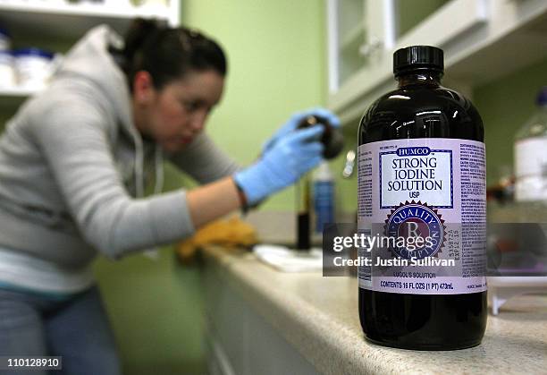 Worker at West Marin Pharmacy fills vials with strong iodine solution on March 15, 2011 in Point Reyes Station, California. In the wake of explosions...