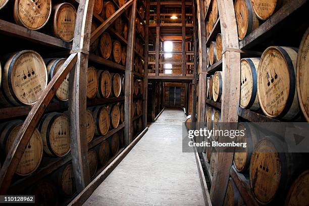 Oak barrels filled with Woodford Reserve bourbon whiskey are stored in a warehouse during the aging process at the company's distillery in...