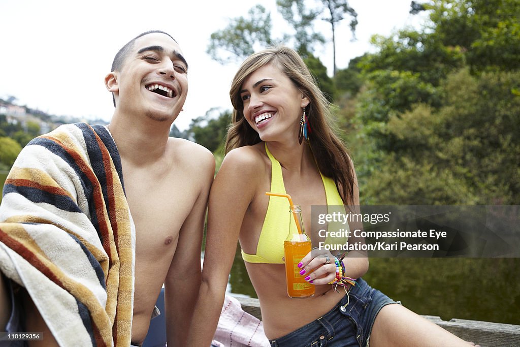 Young couple in bathing suits laughing