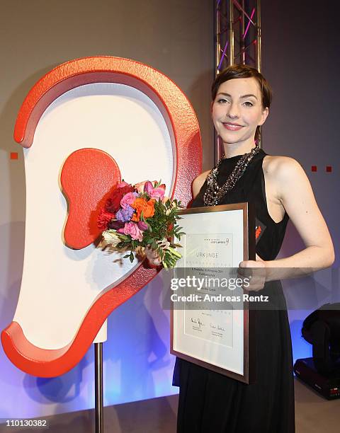 Actress Katharina Schuettler poses with her award during the 'Deutscher Hoerfilmpreis 2011' at the Atrium Deutsche Bank on March 15, 2011 in Berlin,...