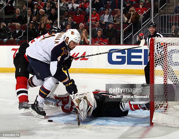 Martin Brodeur of the New Jersey Devils stops Zach Bogosian of the Atlanta Thrashers during the first period at the Prudential Center on March 15,...