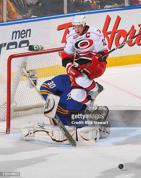 Eric Staal of the the Carolina Hurricanes jumps in front of Ryan Miller of Buffalo Sabres at HSBC Arena on March 15, 2011 in Buffalo, New York.