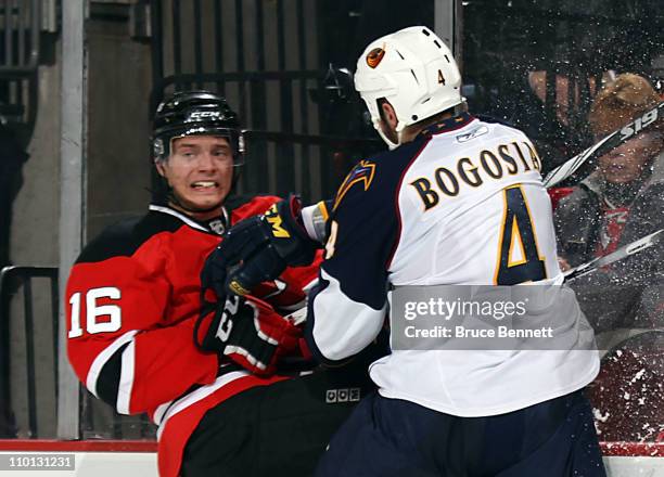 Zach Bogosian of the Atlanta Thrashers hits Jacob Josefson of the New Jersey Devils at the Prudential Center on March 15, 2011 in Newark, New Jersey.