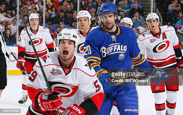 Chad LaRose of the Carolina Hurricanes heads to the bench to celebrate a first period goal with teammates along the bench as Rob Niedermayer of the...