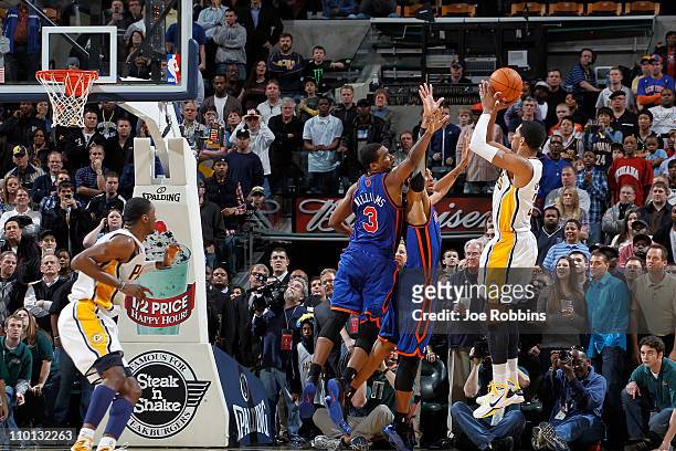 Danny Granger of the Indiana Pacers takes the game-winning shot over Shawne Williams and Jared Jeffries of the New York Knicks on March 15, 2011 at...
