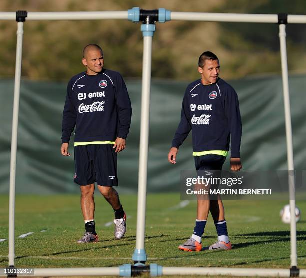 Chile's striker Alexis Sanchez walks with striker Humberto Suazo during a training session in Nelspruit on June 19, 2010 during the 2010 World Cup in...