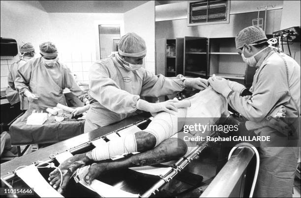 The burns victims in Clamart, France in March, 1999 - In the center's bathroom, doctors and nurses bandage a patient's burns.