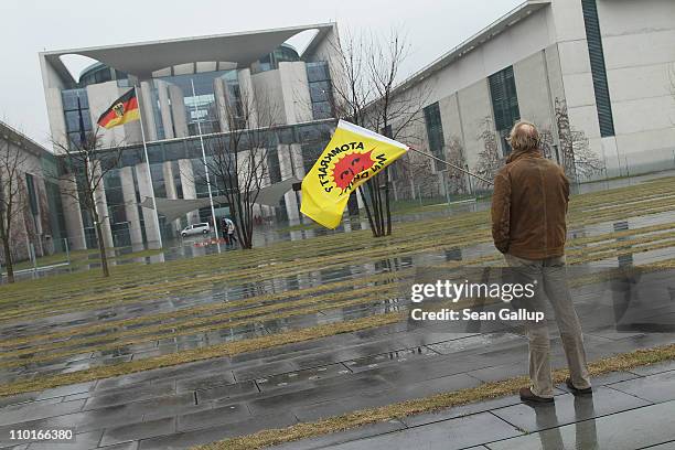 Lone anti-nuclear activist holds vigil in front of the Chancellery while holding a flag that reads: "Nuclear Power? No Thanks!" on March 16, 2011 in...