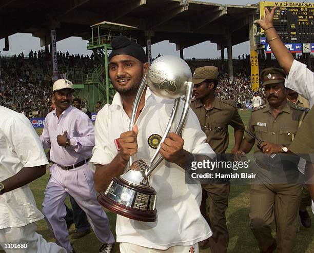 Harbhajan Singh of India runs with the trophy during a lap of honour, after India won the series, during day five of the third test between India and...