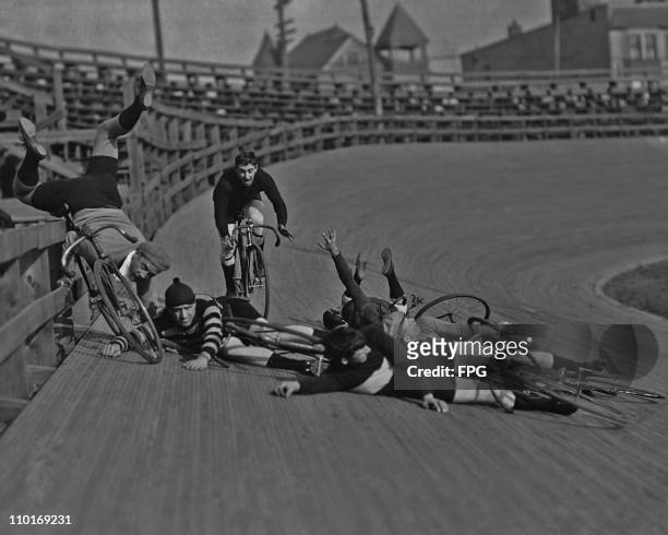 Group of men crash during a cycling race at a velodrome circa 1920's.