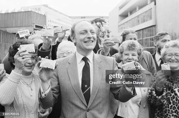 Labour leader Neil Kinnock distributes butter from the surplus known as the 'butter mountain' to a group of receptive ladies, 2nd April 1984.