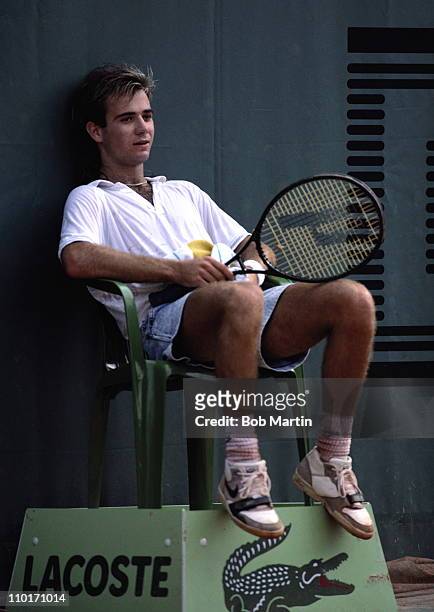 Andre Agassi of the United States wearing his jean style shorts sits down to take a break during a Men's Singles match against Massimiliano Narducci...