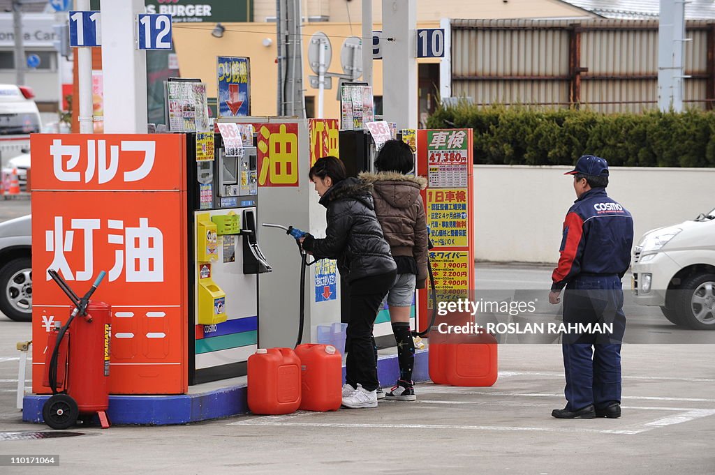 Residents fill up jerrycans with gasolin